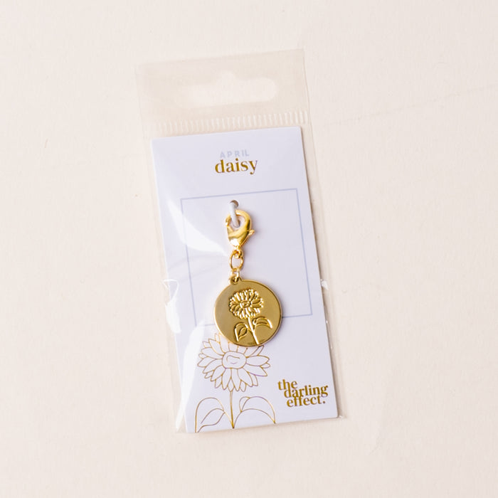 April Jewelry Birth Flower Charm Gold by the-darling-effectβan elegant, meaningful accessory, presented on a card that reads "April Daisy," perfect for fans of personalized jewelry.