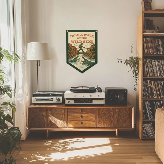 Mid-century cabinet with record player, speaker, lamp; Benoit’s Take A Walk On The Wild Side felt banner hanging above.