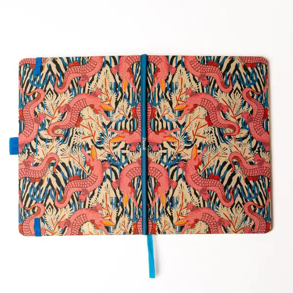 Denik Animal Print Soft Touch Layflat Notebook with pink dragon cover, hardbound spine, and blue ribbon bookmark.