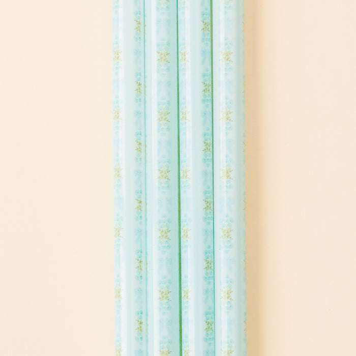 A close-up, vertical shot features several the-darling-effect Oh So Fancy Blue 40 oz Tumbler Straws, all BPA-free and patterned, displayed against a pale peach background.