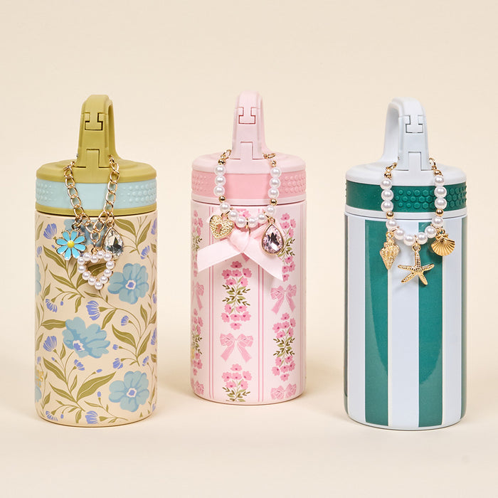 The Darling Effect's Book Shelfie 6 oz Lil' Bitty Bottle features floral designs, pink and green stripesβperfect as a stylish travel companion.