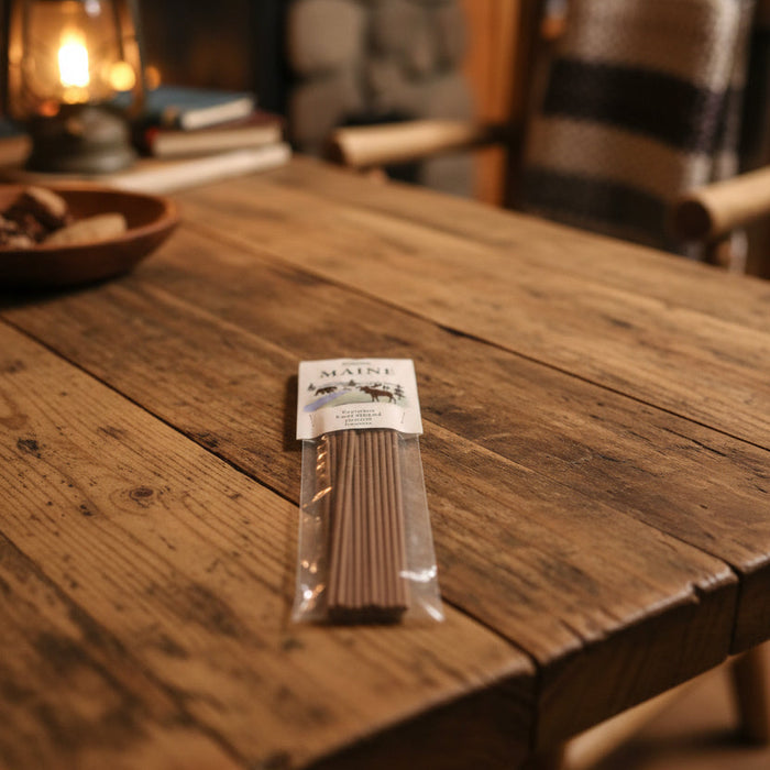 Paines Maine 20 Incense Sticks box on wooden table, rich pine scent filling room, premium natural incense for home fragrance.