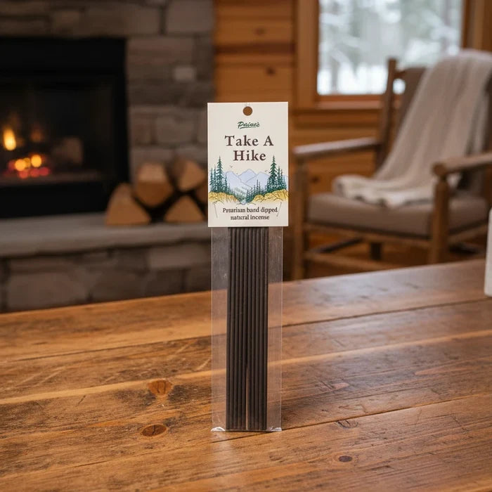 PAINES Take A Hike 20 Incense Sticks box on wooden table in cozy room, premium natural incense for home fragrance.