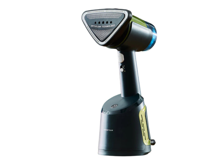 Handheld steamer on a table with text 'Auto-Off for Peace of Mind' in a blurred indoor setting.