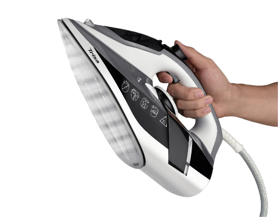 Hand holding a white and black iron against a gray background