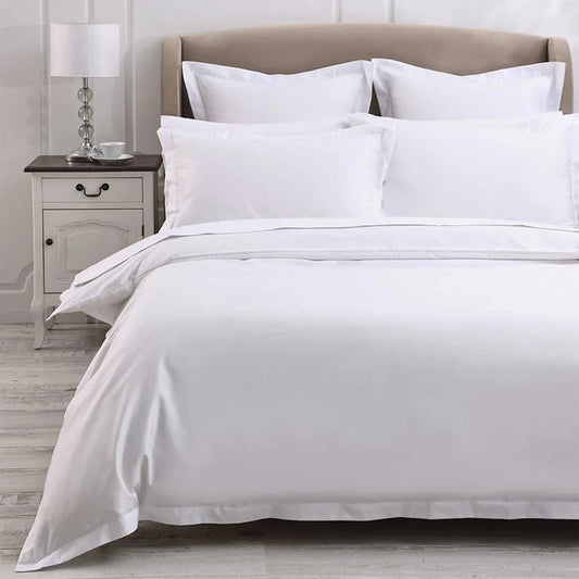 300TC Cotton White Duvet Cover Set on a bed with a nightstand and lamp in the background.
