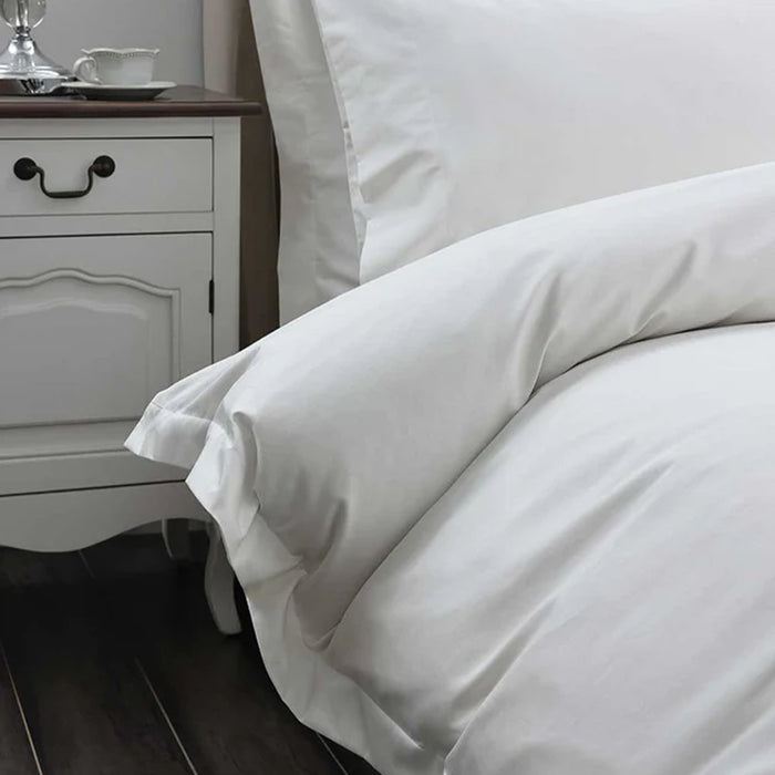 300TC Cotton Ivory Duvet Cover Set on a bed in a bedroom setting with a nightstand.