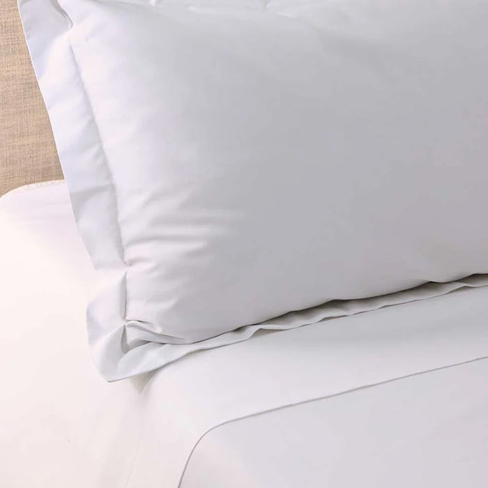 Close-up of 300TC Cotton White Fitted Sheets on a bed with a neutral background