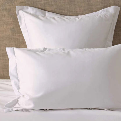 300TC Cotton White Pillowcase on a bed with a neutral headboard.