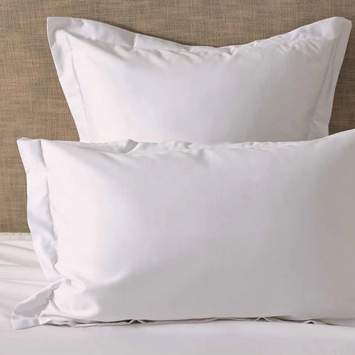 300TC Cotton White Pillowcase on a bed with a neutral headboard.