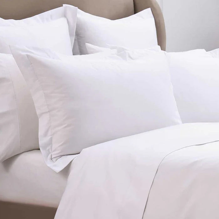 300TC Cotton White Pillowcase on a bed with beige bedding