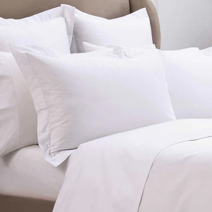 300TC Cotton White Pillowcase on a bed with beige bedding