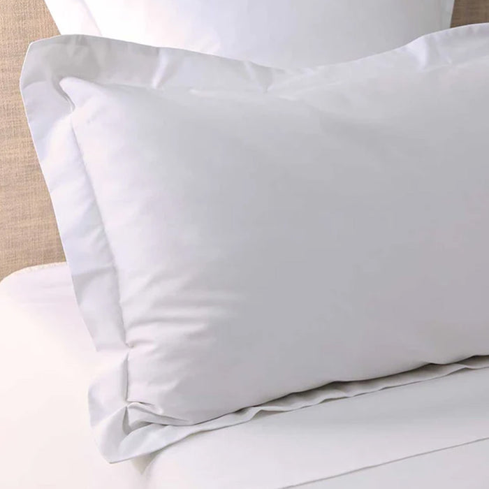 300TC Cotton White Pillowcase on a bed with beige headboard