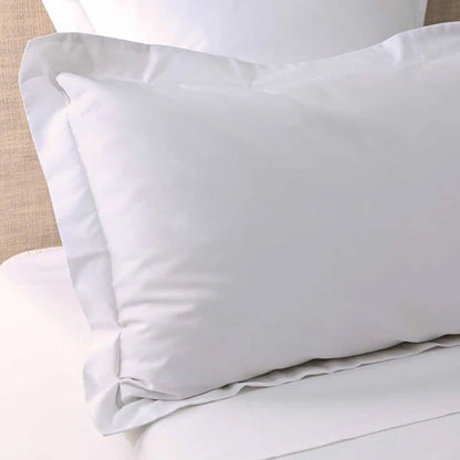 300TC Cotton White Pillowcase on a bed with beige headboard
