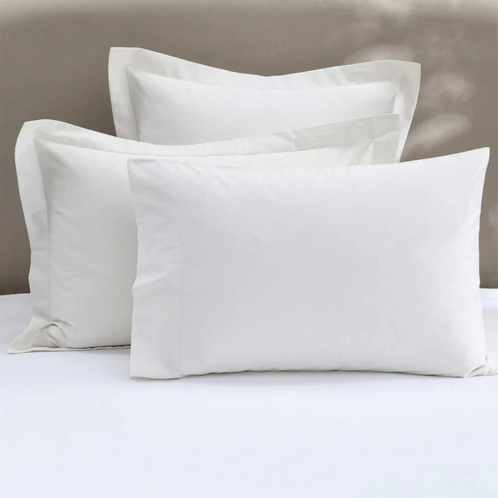 300TC Cotton Ivory Pillowcase on a bed with a neutral background