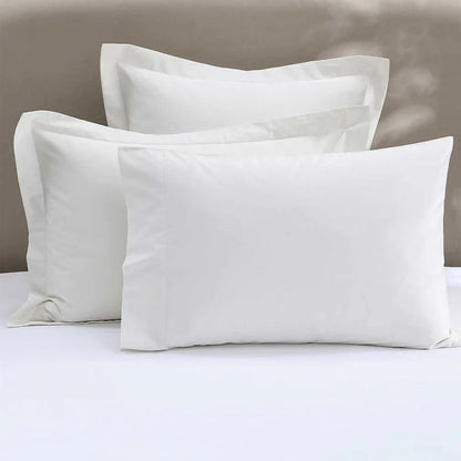 300TC Cotton Ivory Pillowcase on a bed with a neutral background