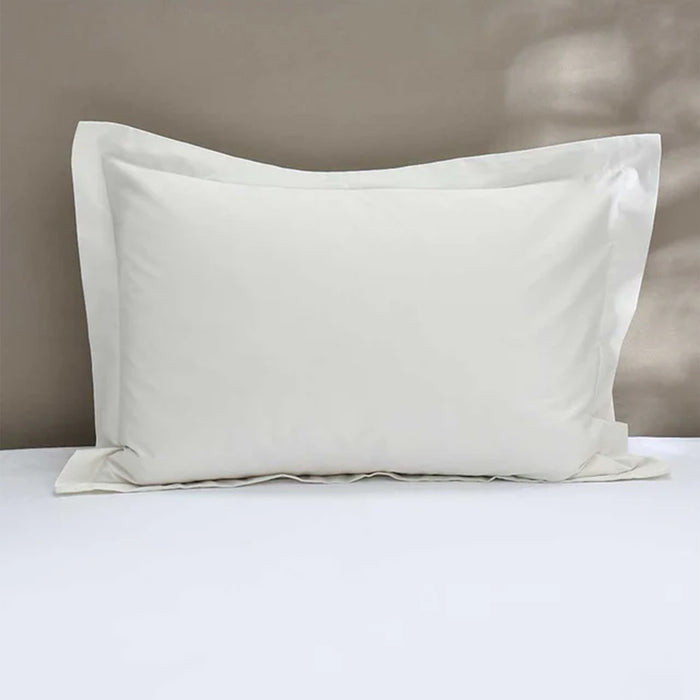 300TC Cotton Ivory Pillowcase on a bed with a neutral background