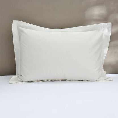 300TC Cotton Ivory Pillowcase on a bed with a neutral background