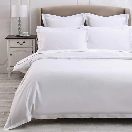 Neatly made bed with 500TC Egyptian Cotton White Duvet Cover Set in a bedroom setting.