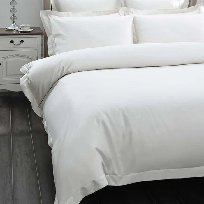 500TC Egyptian Cotton Ivory Duvet Cover Set on a bed with a nightstand in the background