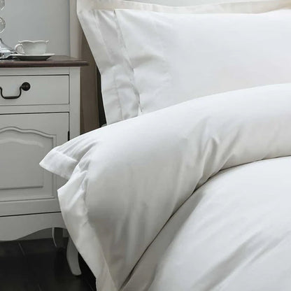 500TC Egyptian Cotton Ivory Duvet Cover Set on a bed with a nightstand in the background