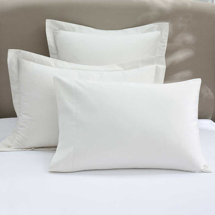 500TC Egyptian Cotton White Pillowcase on a bed with a neutral headboard.