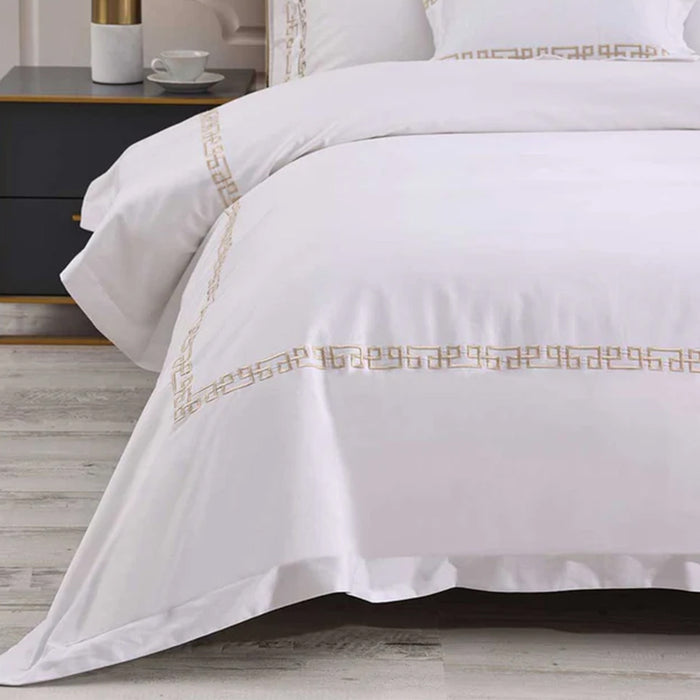 Ares Champagne Duvet Cover Set on a bed in a bedroom setting.