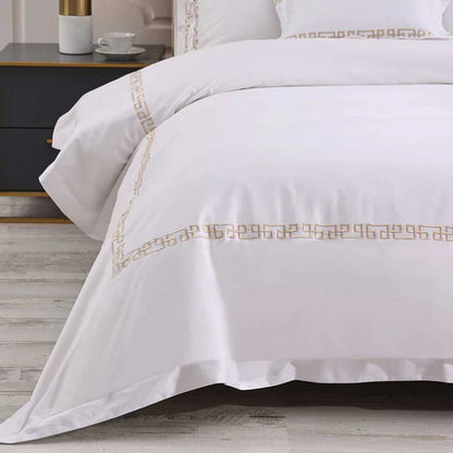 Ares Champagne Duvet Cover Set on a bed in a bedroom setting.