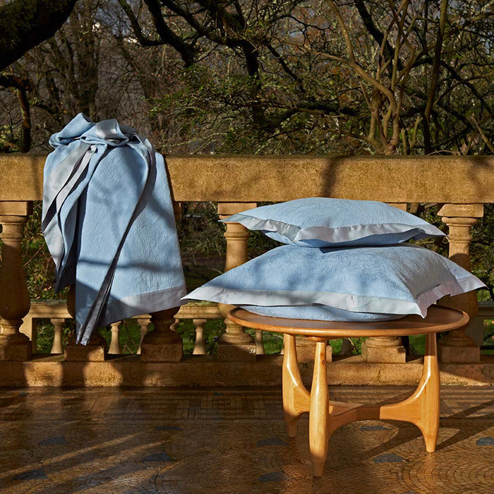 Aura-Tivoli pillowcase on a wooden table and Aura-Tivoli bedspread with a natural background