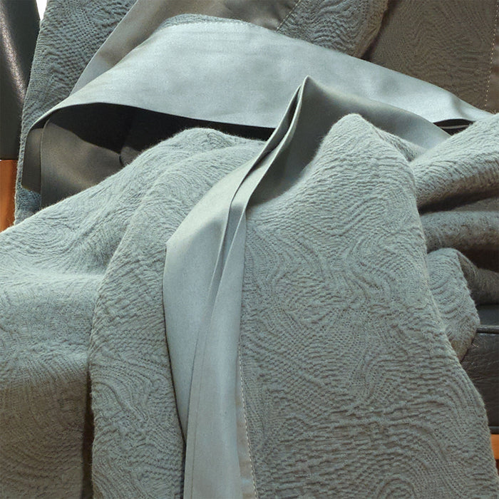 Aura-Pewter bedspread draped over a chair