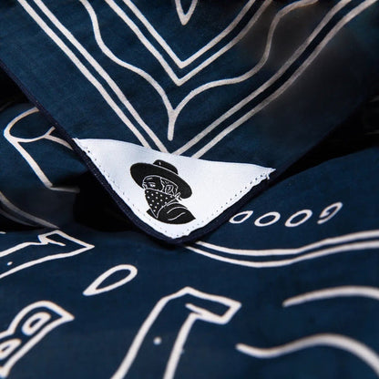 Navy “Good Luck” organic cotton bandana by Bandit Bandanas, vintage style, white details, logo tag. Cotton scarf accessory.