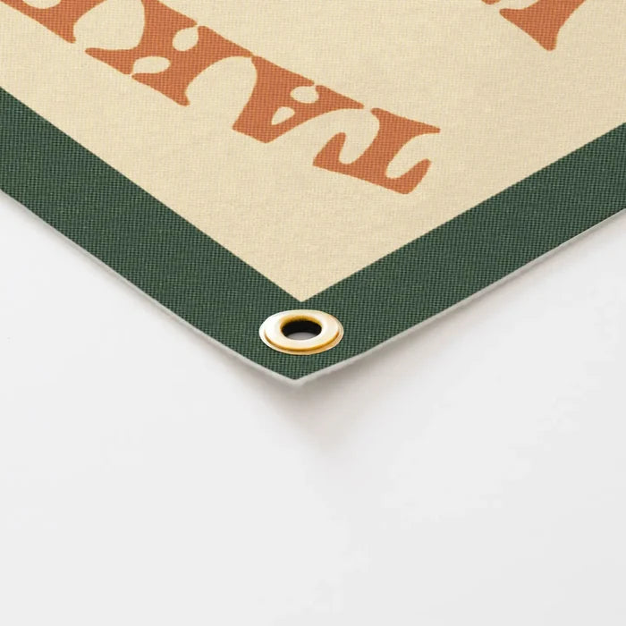 Close-up of Benoit’s Design Co felt banner, "Take A Walk On The Wild Side", green border, metal grommet, stylish room decor.