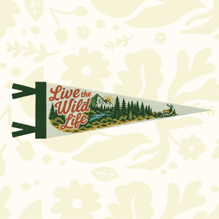 Benoit’s “Live the Wild Life” 8x28.5” felt pennant features trees, mountains & deer—perfect rustic cabin or camp decor.