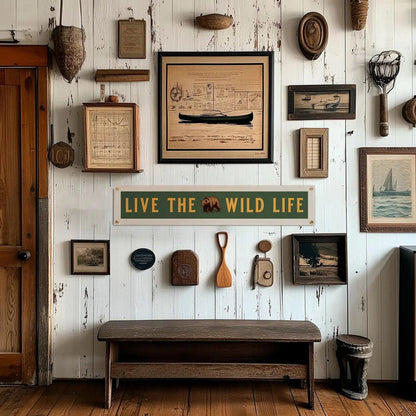 Forager Provisions LTD felt pennant banner with Live The Wild Life text and bear graphic hanging on a rustic wall.