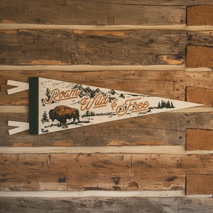 Forager Provisions LTD Benoit’s Design Co felt pennant with Roam Wild & Free bison and mountain graphic on log wall