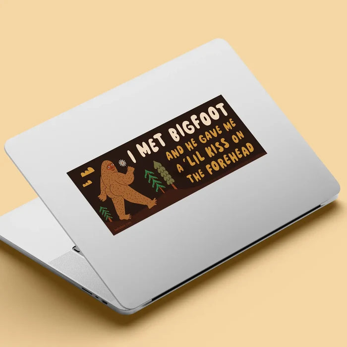 Silver laptop featuring a Betiobca bumper sticker: “I Met Bigfoot and He Gave Me A Little Kiss” funny cryptid gift.