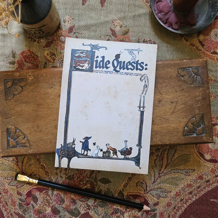 Betiobca “Side Quests” Medieval Notepad for RPGs, with pencil and candles on ornate fabric—perfect gift for gamers.