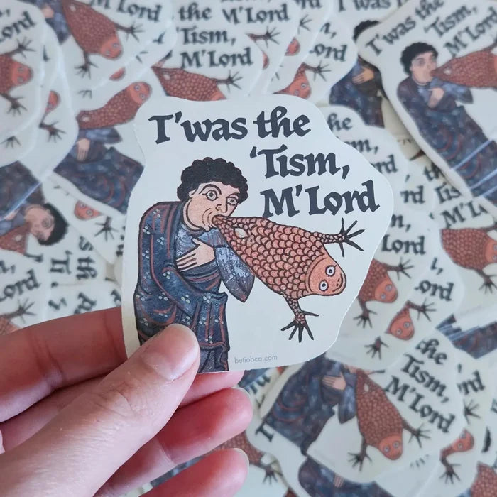 Hand holding Betiobca’s “T’was The Twism, M’Lord” vinyl sticker featuring a humorous medieval figure and witty design.