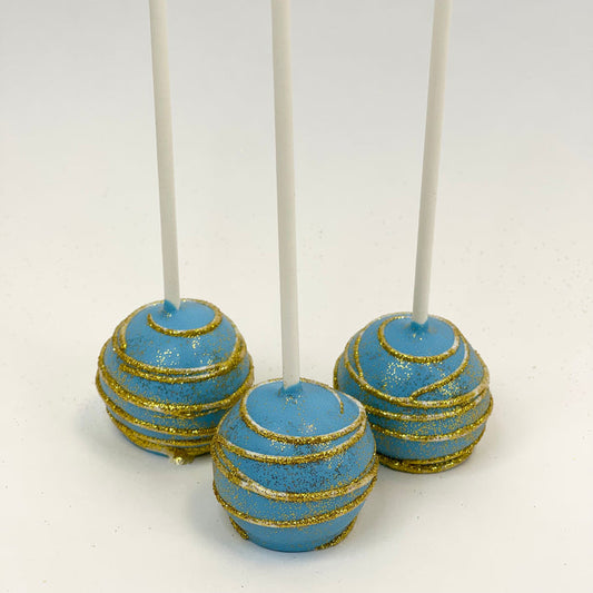 Three Cake Pop dipped in blue chocolate with white swirl dust in gold glitter