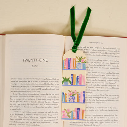 An open book displaying chapter twenty-one with the Book Shelfie Acrylic Bookmark on top, featuring bookshelf and plant illustrations plus a green velvet ribbon—an ideal gift for book lovers.