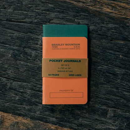 Bradley Mountain Pocket Journals 2 Pack in Orange, perfect for field notes, stylishly on a dark wood desk—premium notebooks.