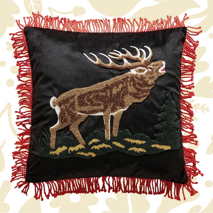 Forager Provisions LTD needle punch elk pillow on black fabric with red tassel trim and lodge-inspired design.