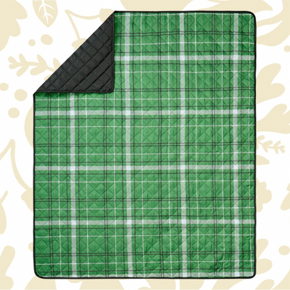Shop the Peking Camp Wandawega picnic blanket with black lining, displayed on a beige leaf-patterned surface for outdoor use.