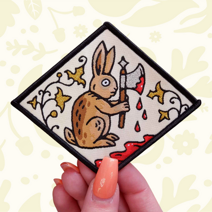 Forager Provisions LTD Cat Coven woven patch featuring a medieval rabbit holding an axe against a manuscript background