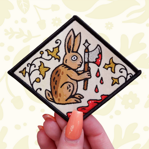 Forager Provisions LTD Cat Coven woven patch featuring a medieval rabbit holding an axe against a manuscript background