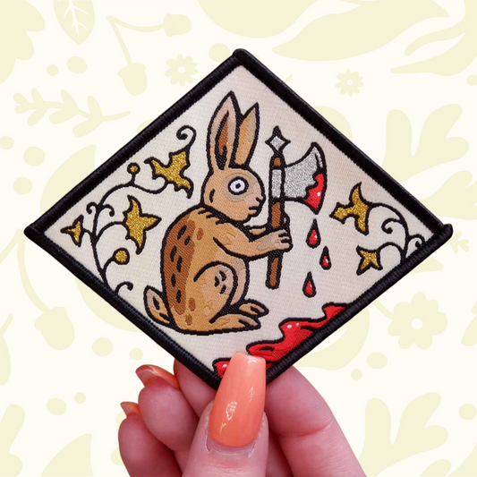 Forager Provisions LTD Cat Coven woven patch featuring a medieval rabbit holding an axe against a manuscript background