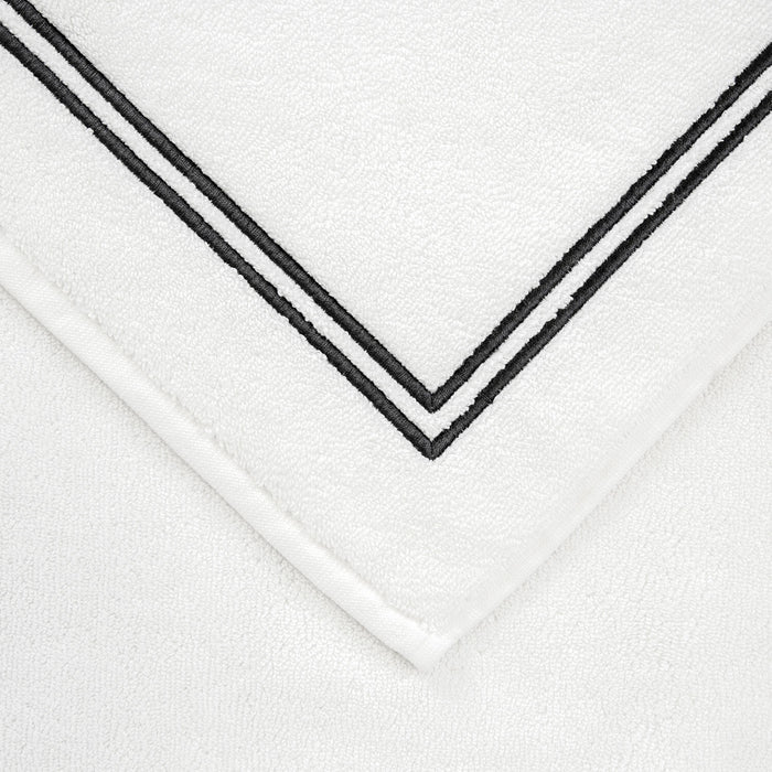 close up shot of the details and fabric of a white grey Classic Bath Mat