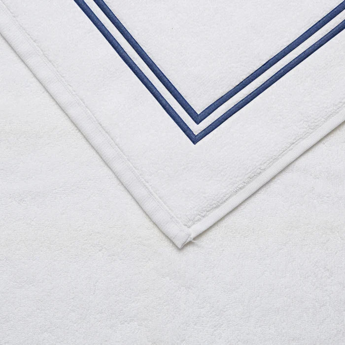 close up shot of the details and fabric of a white navy Classic Bath Mat