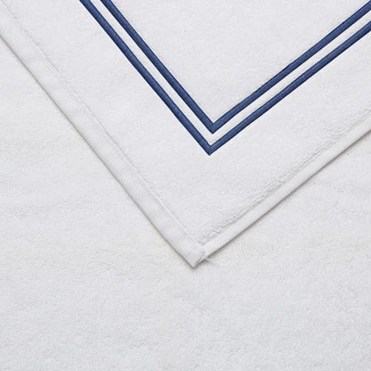 close up shot of the details and fabric of a white navy Classic Bath Mat