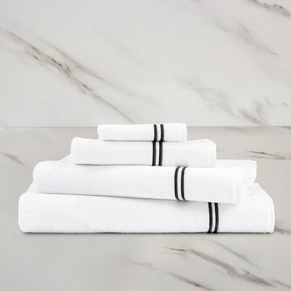 a white grey Classic Bath towel with other Classic towels stacked on on a marbeled surface and background